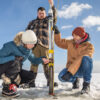 Participants in an eelgrass coring workshop gather sediment cores from an eelgrass meadow, which will be used to establish how long the carbon stored by eelgrass stays locked away.