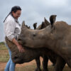 Orphanage manager Claudia Andrione with older rhino orphans at the orphanage.