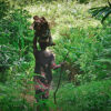A woman carries firewood out of the Mkingu Forest Nature Reserve.