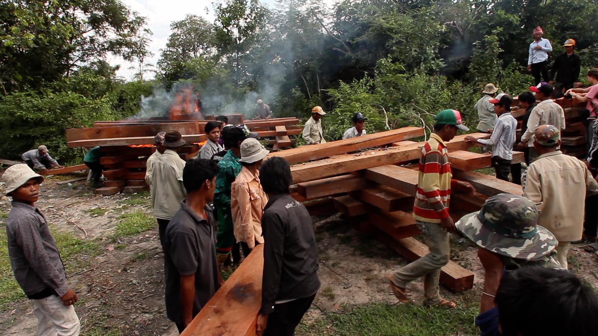In 2011, members of the Prey Lang Community Network, a grassroots activism group intent of preserving the protected area, burn an unmarked stockpile of illegal timber shortly before local authorities attempt to arrest the late forest activist Chut Wutty. Image supplied. 